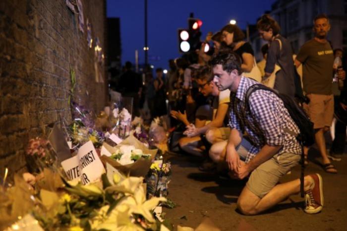 A man looks at messages and tributes left near to where a van was driven at Muslims in Finsbury Park, North London, Britain, June 19, 2017.