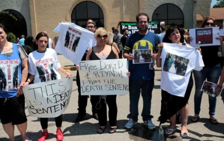 Chaldean-American Nadia Al-Raviah (C) stands with family members protesting against the seizure of her husband and brother Sunday by Immigration and Customs Enforcement agents during a rally outside the Mother of God Chaldean church in Southfield, Michigan, U.S., June 12, 2017.