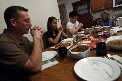 Family prays before a meal.