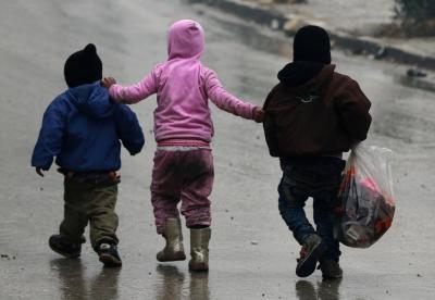 Children walk together as they flee deeper into the remaining rebel-held areas of Aleppo, Syria December 13, 2016.
