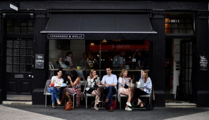 Customers sit outside the Fernandez & Wells Cafe in Kensington in London, Britain, May 29, 2017.