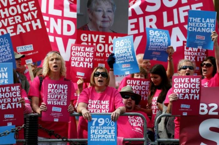 Pro ''assisted dying'' campaigners protest outside the Houses of Parliament in central London, Britain September 11, 2015.
