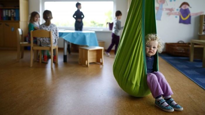 Children wait for their teacher at a preschool in Sweden.