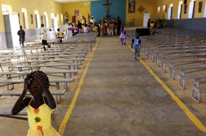 A South Sudanese girl living in the North reacts during Christmas day celebrations at a Catholic church in the Umbada locality of Omdurman December 25, 2013.
