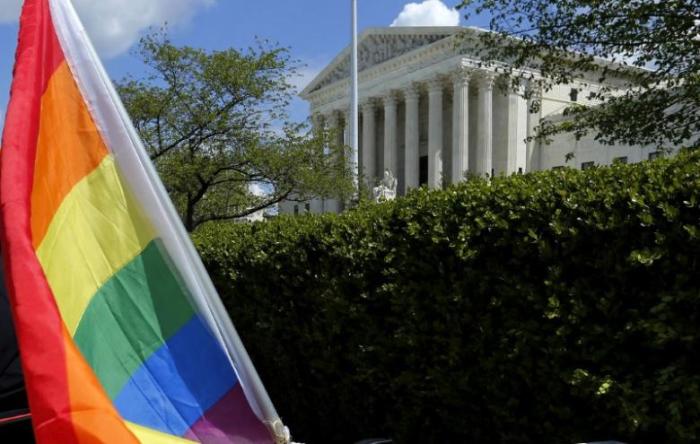 A rainbow-colored flag is seen outside the U.S. Supreme Court in Washington, U.S. on April 27, 2015.