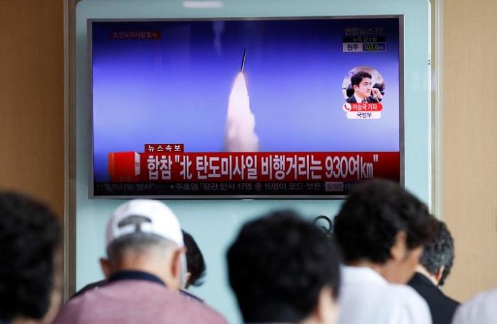 People watch a TV broadcast of a news report on North Korea's ballistic missile test, at a railway station in Seoul, South Korea, July 4, 2017.