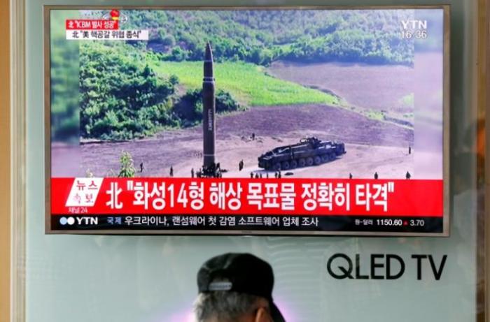 A man watches a TV broadcasting still photographs released by North Korea's state-run television KRT of North Korea's Hwasong-14 missile, at a railway station in Seoul, South Korea.