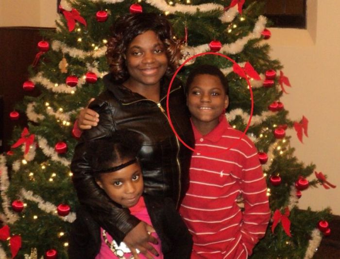 Davion Henderson, 12 (red circle), is pictured with his mother Angela, and sister.