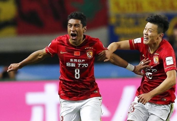 Paulinho (L) of China's Guangzhou Evergrande celebrates with teammate Zou Zheng after scoring against Mexico's Club America during their Club World Cup quarter-final soccer match in Osaka, Japan, Dec. 13, 2015.