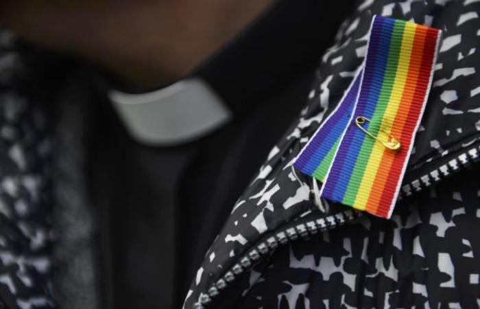 A priest wears a rainbow ribbon during a vigil against Anglican Homophobia, outside the General Synod of the Church of England in London, Britain, February 15, 2017.