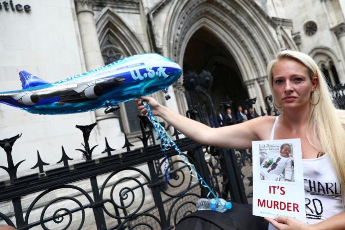 A campaigner holds a banner to show support for allowing Charlie Gard to travel to the United Stated to receive further treatment, outside the High Court in London, Britain, July 10, 2017.