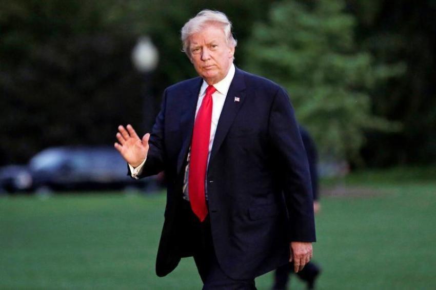 U.S. President Donald Trump waves as walks on the South Lawn of the White House upon his return to Washington, U.S., from the G20 Summit in Hamburg, Germany, July 8, 2017.