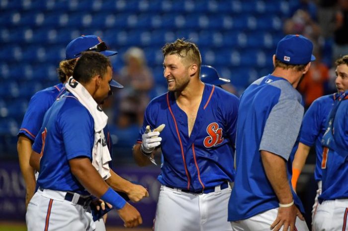 St. Lucie Mets designated hitter Tim Tebow (15) is mobbed by teammates after hitting a walk off solo home run to defeat the against the Daytona Tortugas at First Data Field at Port St. Lucie, Florida, July 13, 2017.