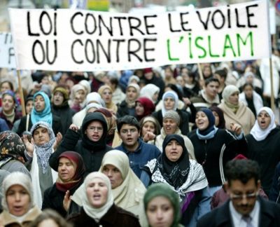 Muslim women demonstrate in favor of the Islamic headscarf in a march in Strasbourg, Eastern France on Dec. 20, 2003. The banner reads: 'A law against the headscarf or against Islam.'