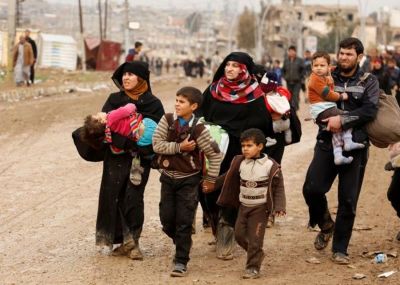 Displaced Iraqis flee their homes as Iraqi forces battle with ISIS militants, in western Mosul, Iraq on March 18, 2017.