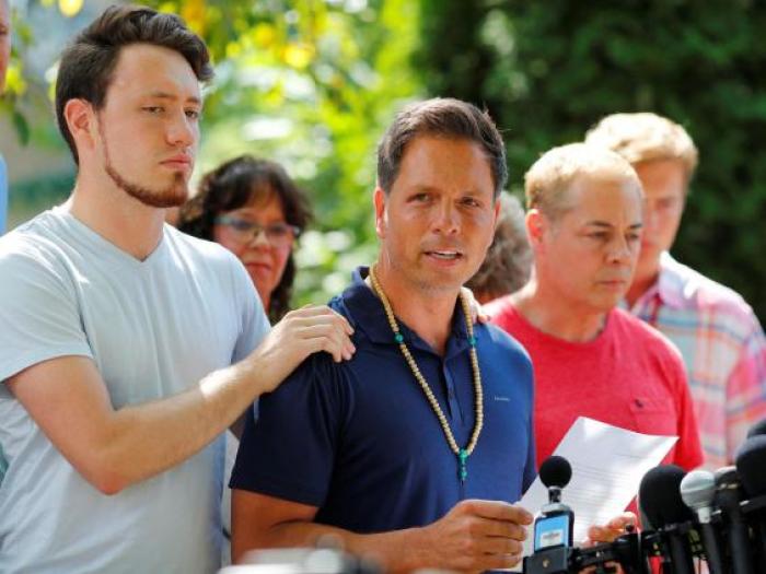 Don Damond is comforted by his son, Zach Damond, as he speaks to the media about his fiance Justine Damond, July 17, 2017.