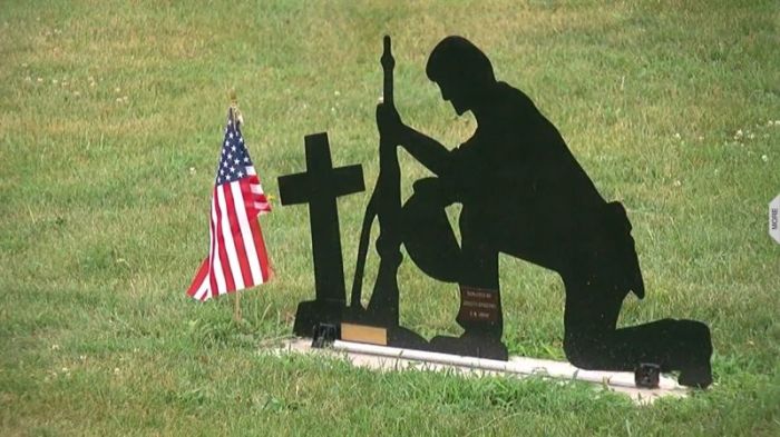 Memorial of 'Joe,' statue of a soldier kneeling at a Christian cross and grave, at Belle Plaine's Veterans Memorial Park in this July 2017 video.