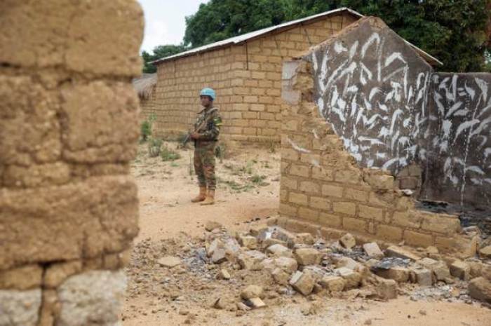 A Bangladeshi United Nations peacekeeping soldier stands among houses destroyed by violence in September, in the abandoned village of Yade, Central African Republic April 27, 2017.