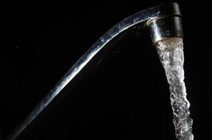 Tap water flows out of a faucet in New York June 14, 2009.