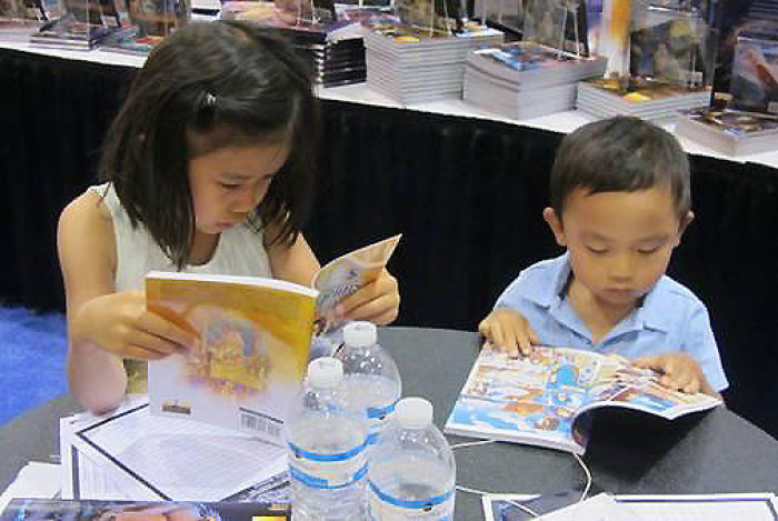 Children reading the Kingstone biblical comics.