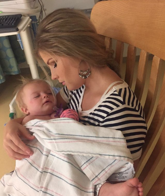 Erin Paine holds her daughter Brooklyn after surgery, July 24, Tennessee.