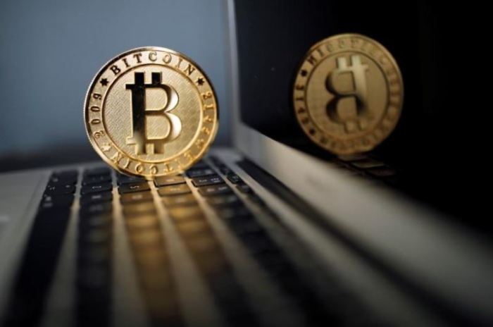 A Bitcoin (virtual currency) coin is seen in an illustration picture taken at La Maison du Bitcoin in Paris, France, June 23, 2017.