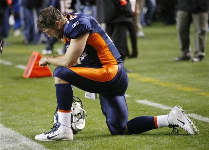 Denver Broncos quarterback Tim Tebow kneels before their game against New York Jets in Denver, November 17, 2011.