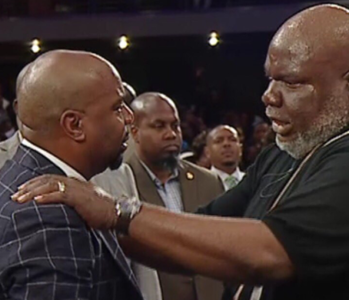 Bishop T. D. Jakes of Potter's House of Dallas (R) lays hands on former senior pastor of The Potter's House Church of Denver, Chris Hill (L) during an emotional service on Sunday August 6, 2017.