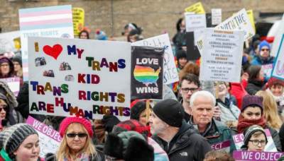 Demonstrators hold signs during 'Stand Up for Transgender Rights' event to show their support for transgender equality, in Chicago, Illinois, U.S. February 25, 2017.