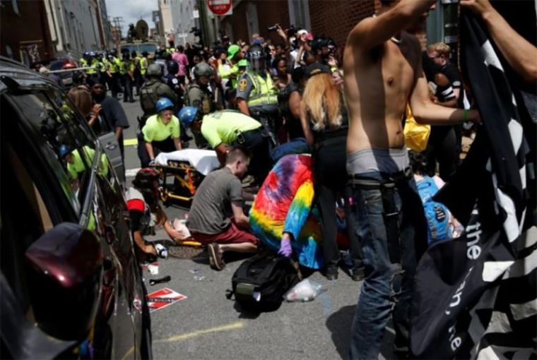 Rescue workers assist people who were injured when a car drove through a group of ANTIFA and Black Lives Matter counter protestors at a KKK rally in Charlottesville, Virginia, August 12, 2017.