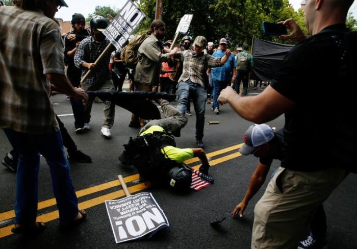 A man hits the pavement during a clash between white nationalist protesters and a group of counter-protesters in Charlottesville, Virginia, August 12, 2017.