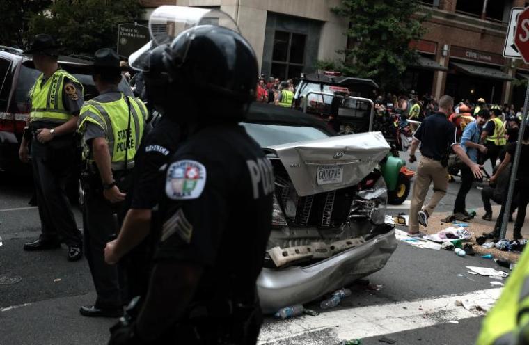 First responders stand by a car that was struck when a car drove through a group of counter protesters at a KKK rally in Charlottesville, Virginia, August 12, 2017.