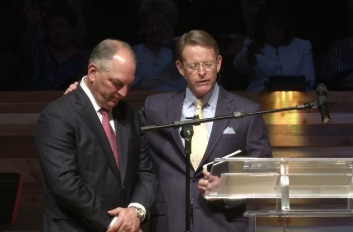 Family Research Council President Tony Perkins and Louisiana Gov. John Bel Edwards pray together during a service at Greenwell Springs Baptist Church in Greenwell Springs, Louisiana on Aug. 13, 2017.