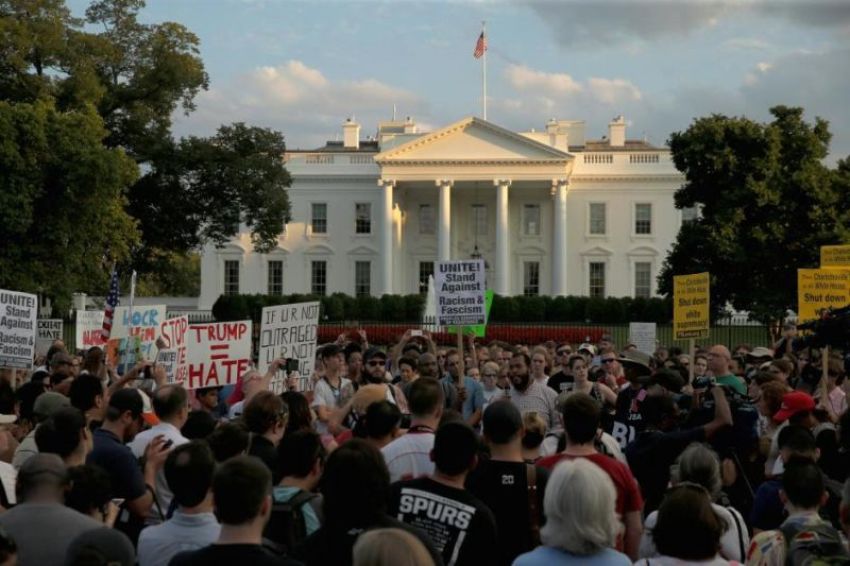 People gather for a vigil in response to the death of a counter-demonstrator at the "Unite the Right" rally in Charlottesville, outside the White House in Washington, U.S. August 13, 2017.
