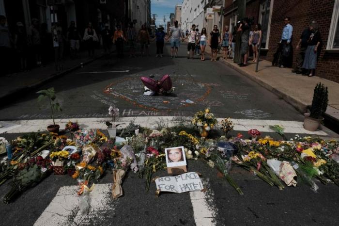 Flowers and a photo of car ramming victim Heather Heyer lie at a makeshift memorial in Charlottesville, Virginia, August 14, 2017.