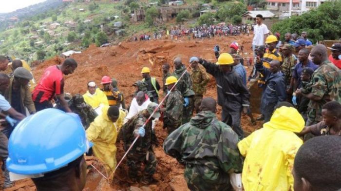 Rescue workers search for survivors after a mudslide in the Mountain town of Regent, Sierra Leone, August 14, 2017.