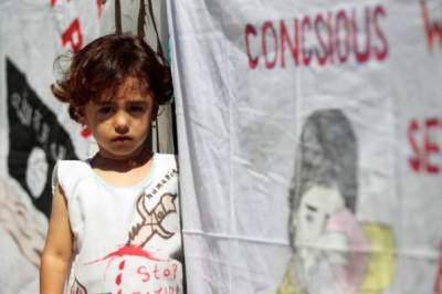 An Iraqi Yazidi refugee girl attends a commemoration of the third anniversary of the Yazidi genocide in Sinjar region, in the village of Nea Apollonia where more than 400 Yazidis live in apartments provided by a UNHCR-sponsored housing scheme, near Thessaloniki, Greece, August 3, 2017.