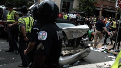 First responders stand by a car that was struck when a car drove through a group of counter protesters at the 'Unite the Right' rally.
