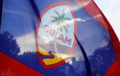 Local residents display a Guam flag during a peace rally at Chief Quipuha Park, on the island of Guam, a U.S. Pacific Territory, August 14, 2017.