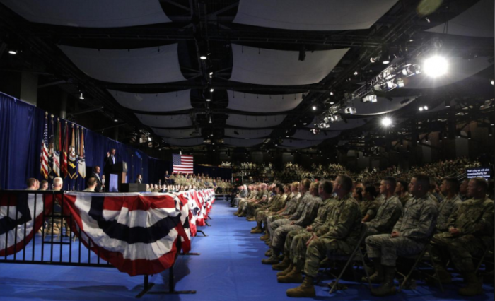 Military personnel watch as U.S. President Donald Trump (L) announces his strategy for the war in Afghanistan during an address to the nation from Fort Myer, Virginia, U.S., August 21, 2017.