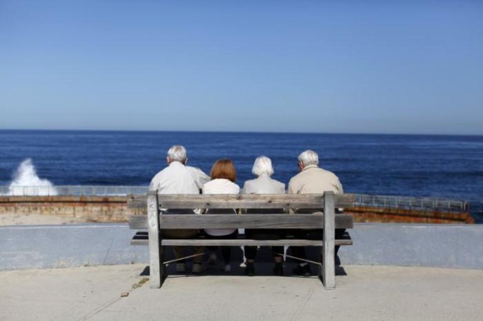 A pair of elderly couples view the ocean and waves along the beach in La Jolla, California, March 8, 2012.