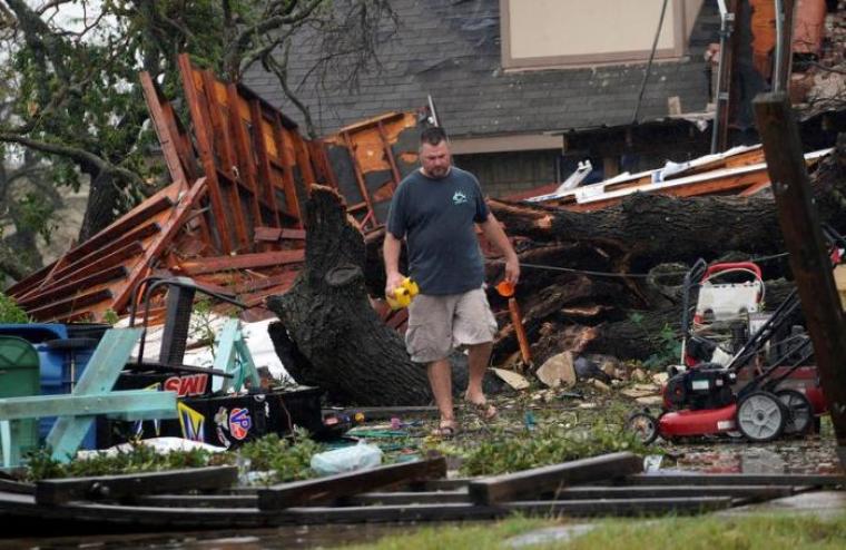 Tim Freiberg moves through what was his garage after Hurricane Harvey struck Rockport, Texas August 26, 2017.