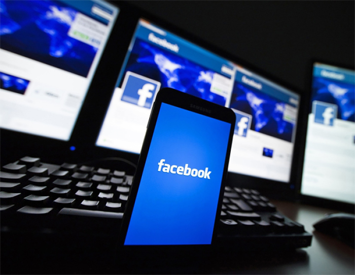 The loading screen of the Facebook application on a mobile phone is seen in this photo illustration.