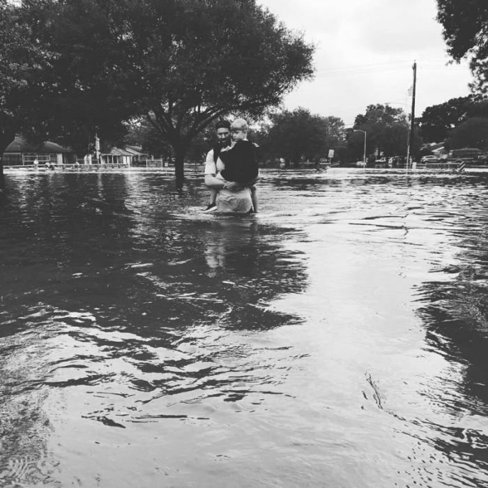Trevor McDonald, Lakewood Church's high school pastor, carries his son as he walks through the flooding caused by Hurricane Harvey in Southeast Texas. The photograph was posted to Facebook on Aug. 27 by Trevor's wife, Amie McDonald.