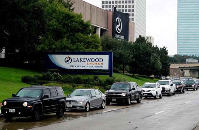 A long line of cars wait to get into the Lakewood church, which was designated as a shelter for Hurricane Harvey victims in Houston, Texas, on August 29, 2017.