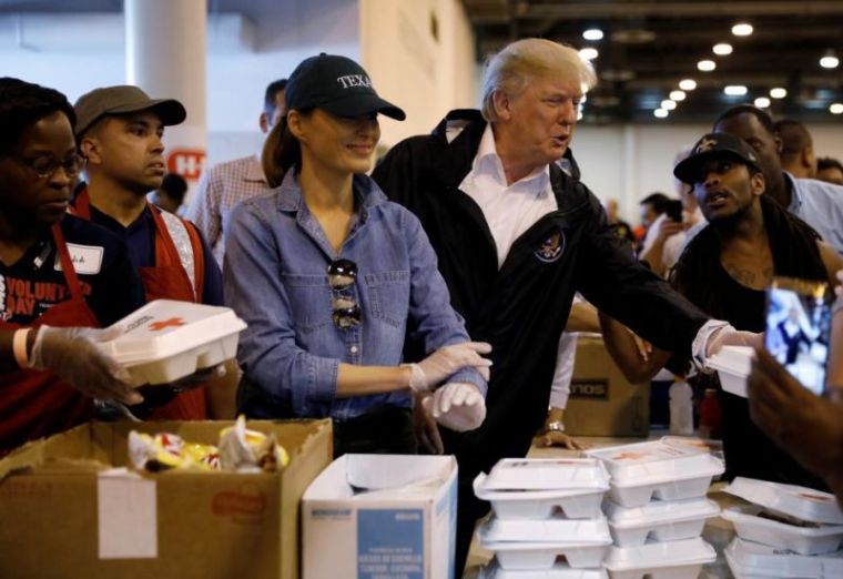 U.S. President Donald Trump and first lady Melania Trump help volunteers hand out meals during a visit with flood survivors of Hurricane Harvey at a relief center in Houston, Texas, U.S., September 2, 2017.