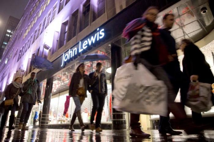 Pedestrians walk past a John Lewis store on Oxford Street in central London in this December 15, 2013 file photo.