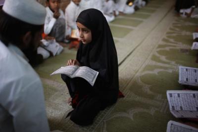 A Muslim girl studies at a Madrassa, or religious school, in the Muslim dominated Johapura area in the western Indian city of Ahmedabad March 3, 2014.