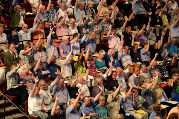 Members of the Church of England's Synod vote on one of the motions during the session during which approved the consecration of women bishops, in York, July 14, 2014.