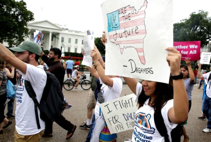 People march outside the White House at a rally calling on President Donald Trump to protect the Deferred Action for Childhood Arrivals program, known as DACA, Washington, D.C. on August 15, 2017.